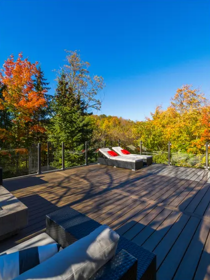 Wood deck surrounded by autumn trees