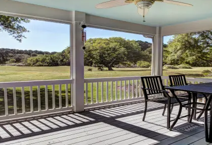 Covered porch with table and chairs